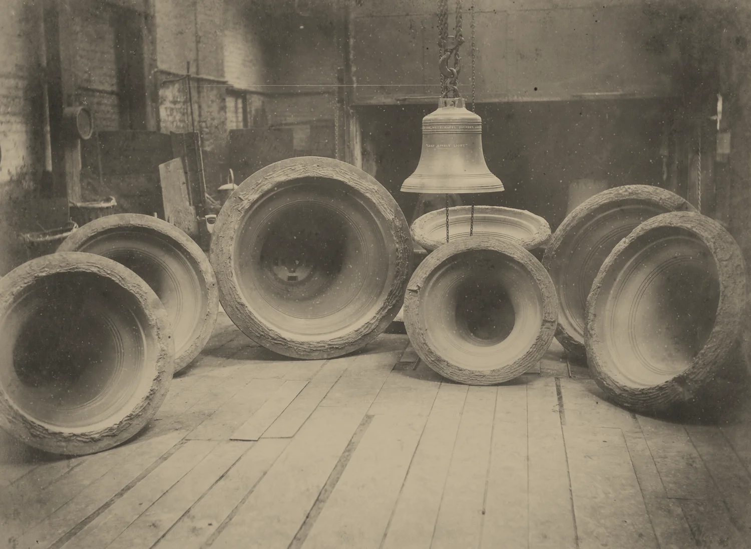 Nineteenth-century bell casting archive: bells resting on a timber workshop floor