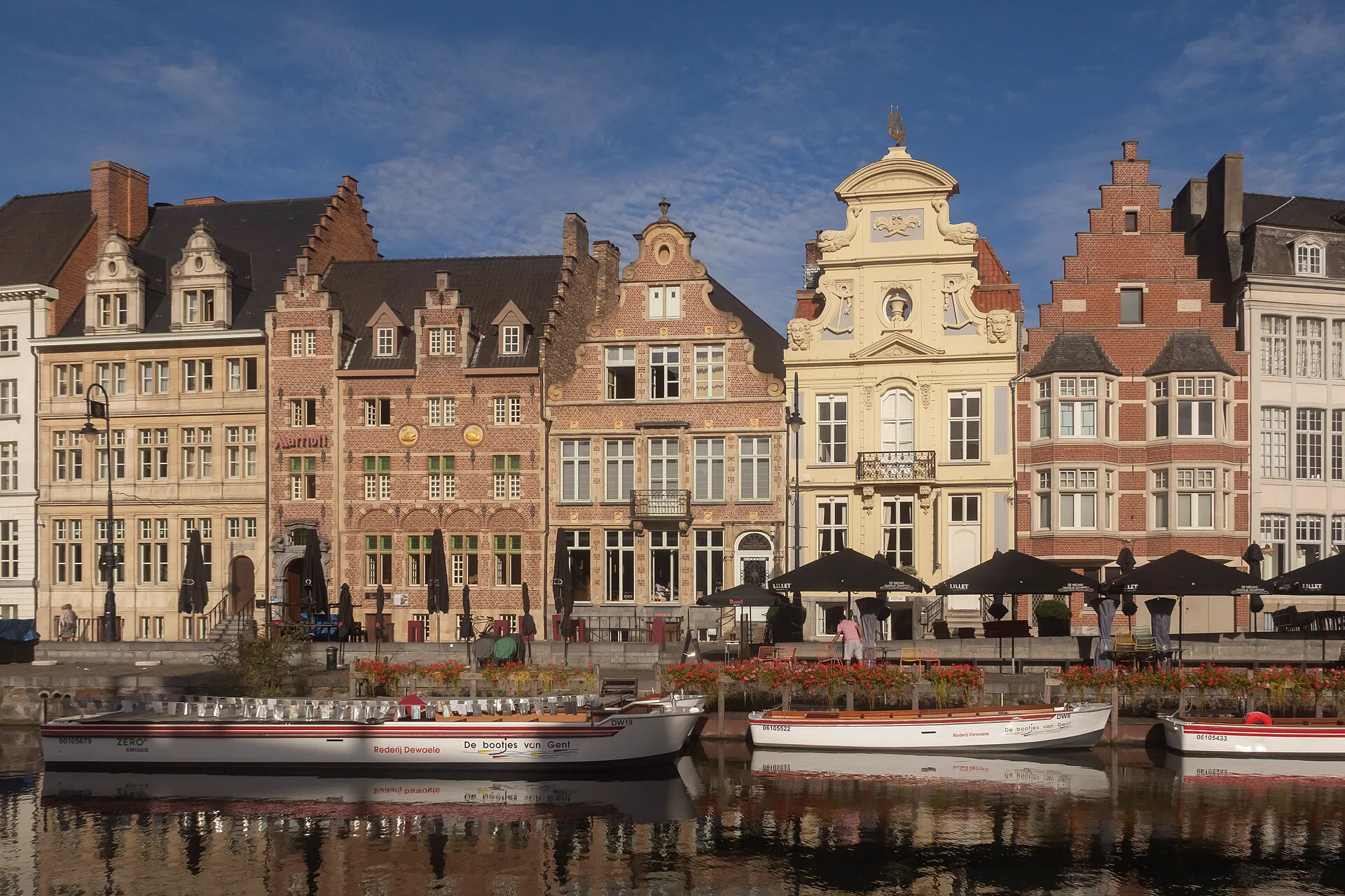 The Korenlei's brick façades and boats on the Leie river in Ghent